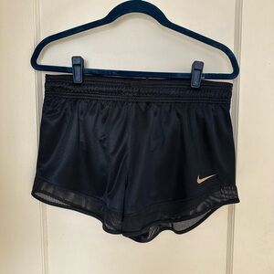 Nike Women's Black Athletic Shorts with Gold Swoosh